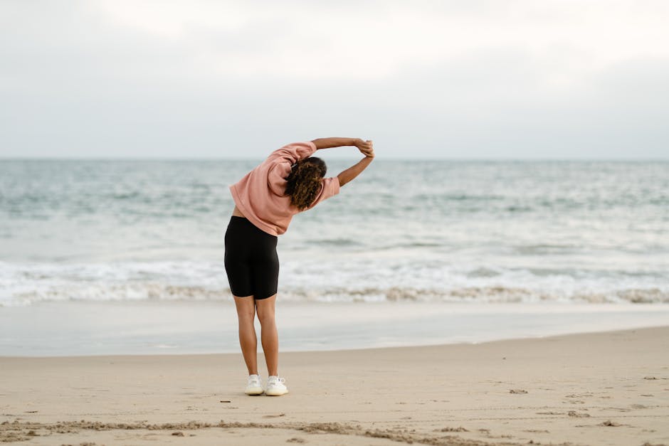 A person feeling refreshed and energized while stretching outdoors at sunrise