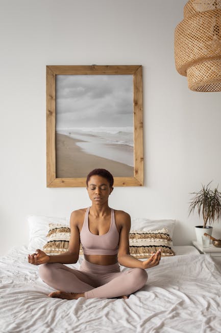Woman in a peaceful yoga pose inside a modern home with soft lighting